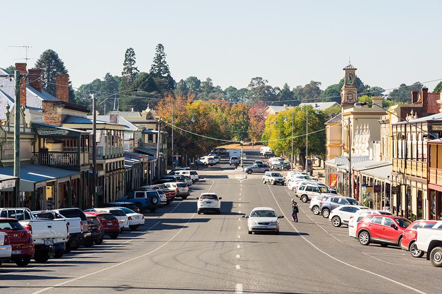 About Our Agency - Small Town Main Street With Shops Along the Road